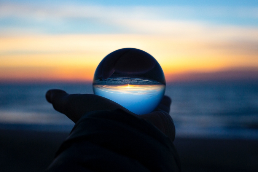 A crystal ball being held up to a horizon